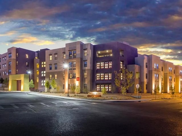 Apartment building with balconies and parking exterior at Casas del Rio in Albuquerque Student Accommodation