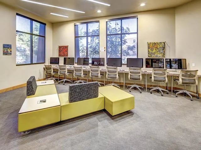 Computers desks chairs lounge seating communal area at Casas del Rio in Albuquerque Student Accommodation