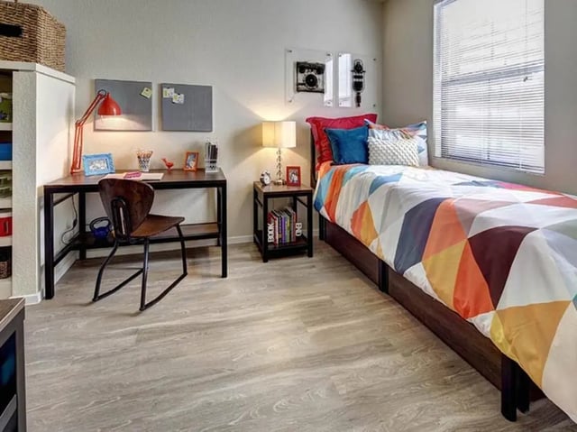 Desk chair bed and pillows bedroom interior at Casas del Rio in Albuquerque Student Accommodation