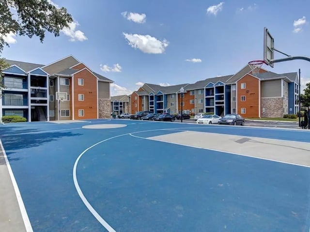 Apartment buildings and basketball court exterior at Campus Edge on UTSA Boulevard in San Antonio Student Accommodation