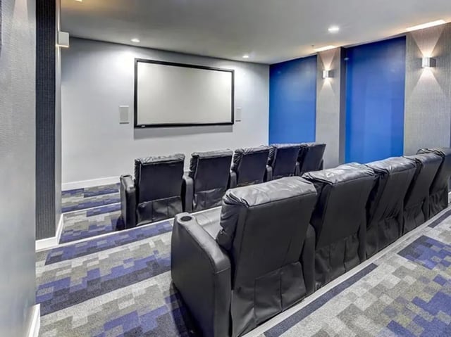 Tiered black leather chairs and screen cinema room at Campus Edge on UTSA Boulevard in San Antonio Student Accommodation