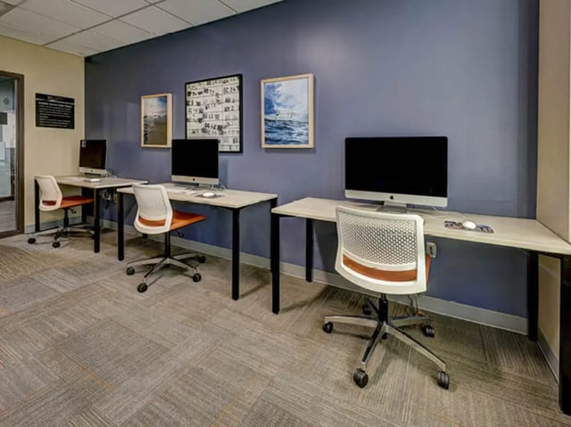 Computer desks with chairs and monitors study area at 8 1/2 Canal Street in Richmond Student Accommodation