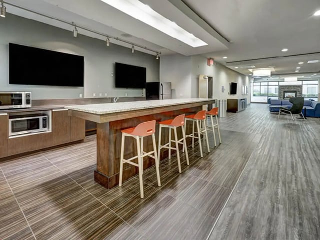 Bar stools at kitchen island with microwaves living room at 8 1/2 Canal Street in Richmond Student Accommodation