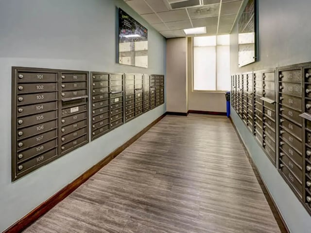 Mailboxes line a hallway with wooden floors and window. at 8 1/2 Canal Street in Richmond Student Accommodation