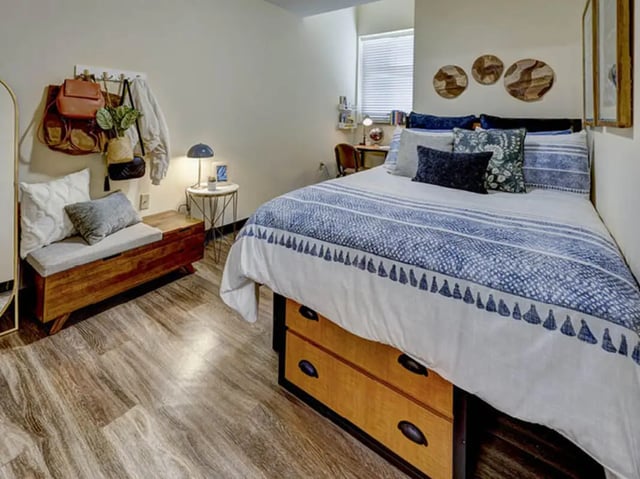 Bed with blue bedding trunk bench and decor Bedroom at 8 1/2 Canal Street in Richmond Student Accommodation