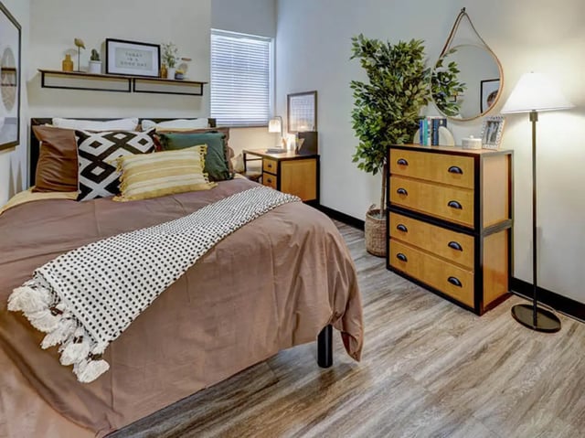 Bed with patterned throw and dresser bedroom at 8 1/2 Canal Street in Richmond Student Accommodation