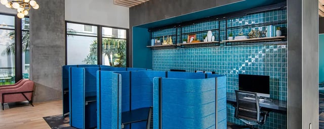 Blue study pods with computers and shelves study area at Currie Hall in Los Angeles Student Accommodation