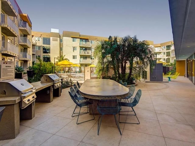 Barbecue grills outdoor seating and tables courtyard at Currie Hall in Los Angeles Student Accommodation