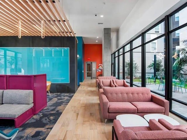 Pink sofas and partition chairs communal living area at Currie Hall in Los Angeles Student Accommodation