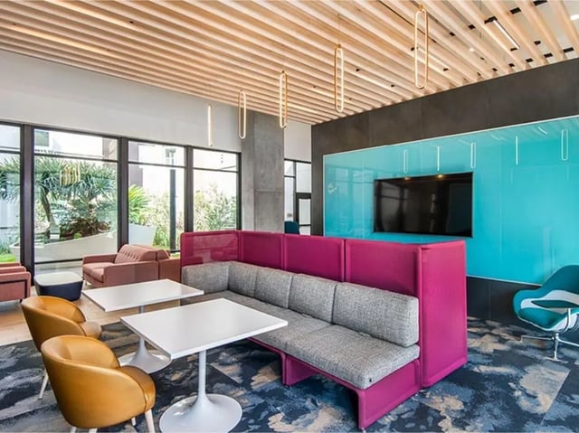 Lounge seating tables and TV lounge area at Currie Hall in Los Angeles Student Accommodation
