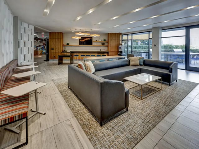 Large sectional sofa with coffee table communal area at Currie Hall in Los Angeles Student Accommodation