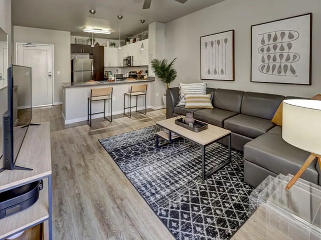 Sofa kitchen island two bar stools living room at Currie Hall in Los Angeles Student Accommodation