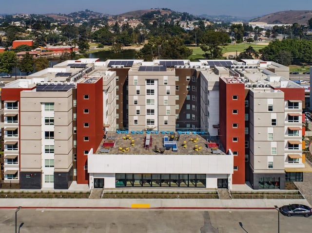 Apartment building with rooftop seating exterior at Currie Hall in Los Angeles Student Accommodation
