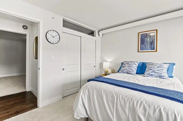 Bed with blue pillows and white duvet bedroom at The Lodge