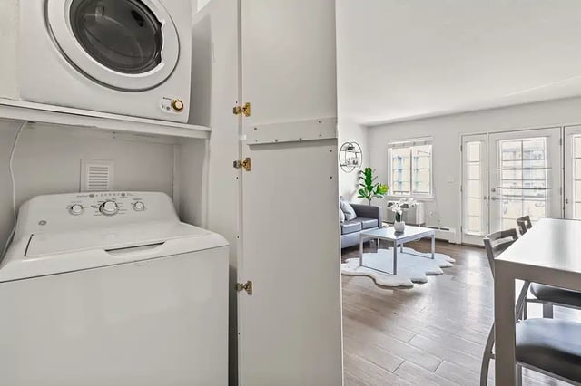 Washer dryer stack visible living room living room at The Lodge