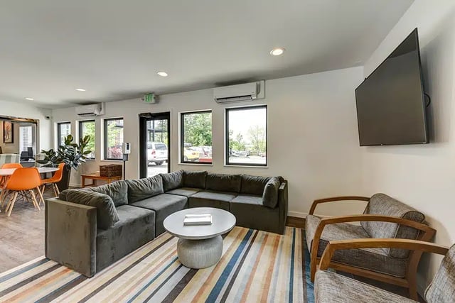 Sectional sofa round coffee table chairs lounge living room at The Lodge