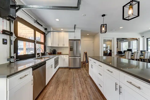 White cabinets stainless steel appliances garage door window kitchen at The Lodge