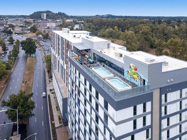 Rooftop pools with seating and mural exterior at 959 Franklin in Eugene Student Accommodation