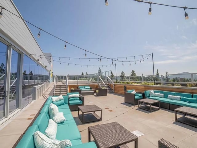 Rooftop patio with teal sofas and tables exterior at 959 Franklin in Eugene Student Accommodation