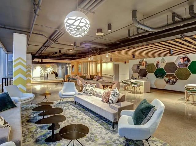 Lounge area with sofas chairs tables and desk common area at 959 Franklin in Eugene Student Accommodation