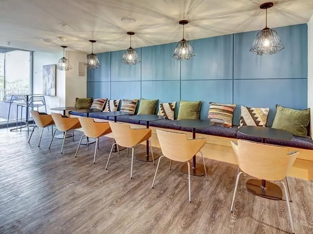 Seating area with tables and chairs communal area at 959 Franklin in Eugene Student Accommodation