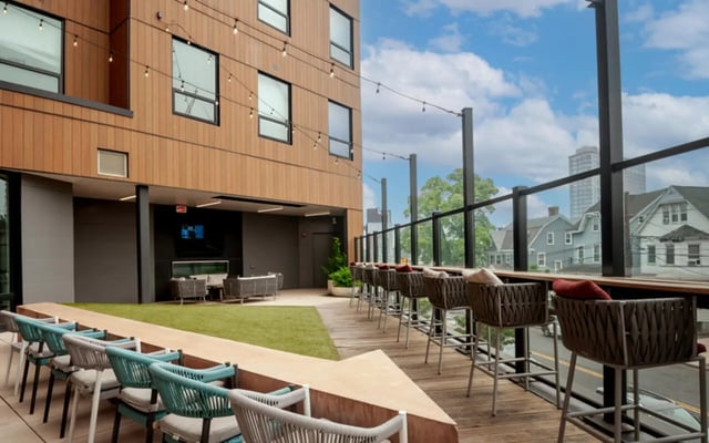 Chairs on grass lounge area and bar seating exterior at Verve New Brunswick in New Brunswick Student Accommodation