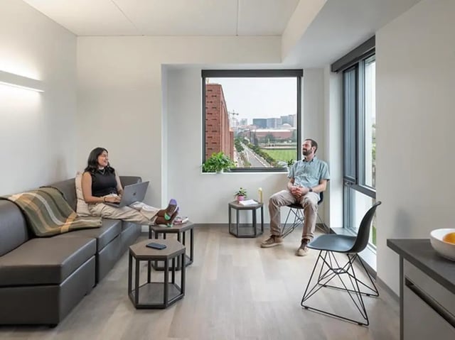 Sofa laptop woman and man sitting living room at Graduate Junction in Cambridge Student Accommodation