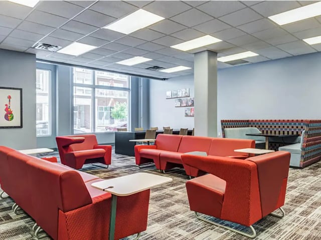 Red couches and chairs in lounge area at GrandMarc Seven Corners in Minneapolis Student Accommodation