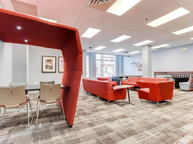 Red booths red couches modern carpeting common area at GrandMarc Seven Corners in Minneapolis Student Accommodation