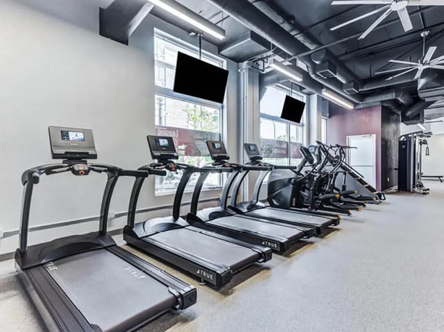 Treadmills and elliptical machines in gym playing area at GrandMarc Seven Corners in Minneapolis Student Accommodation
