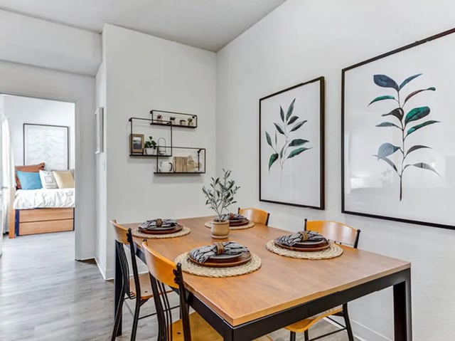 Dining table with chairs artwork and shelves Dining room at GrandMarc Seven Corners in Minneapolis Student Accommodation