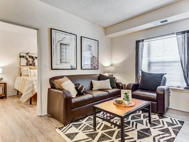 Leather sofa coffee table framed art living room at GrandMarc Seven Corners in Minneapolis Student Accommodation