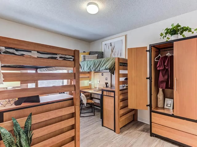 Bunk beds desk closet with clothing bedroom at GrandMarc Seven Corners in Minneapolis Student Accommodation