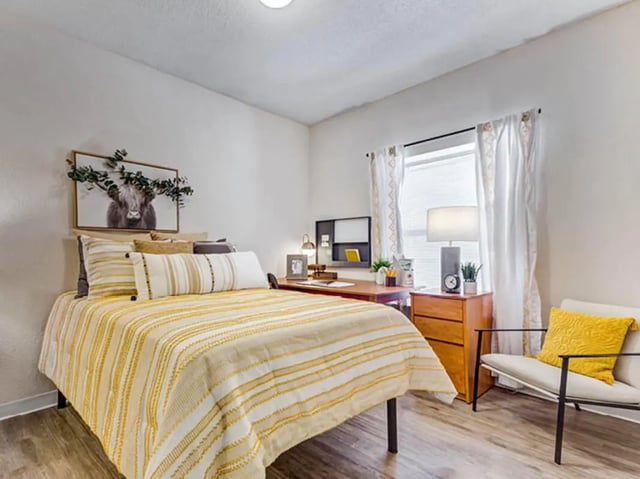 Bed desk chair and artwork bedroom interior at GrandMarc Seven Corners in Minneapolis Student Accommodation