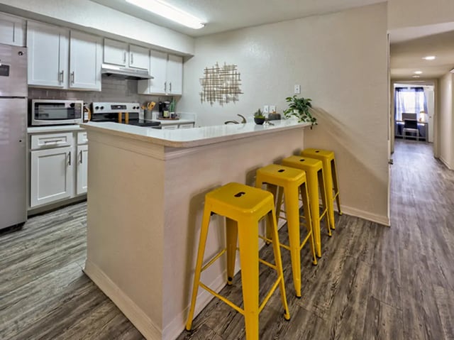 Kitchen with island and yellow stools kitchen at Mercury 3100 in Orlando Student Accommodation