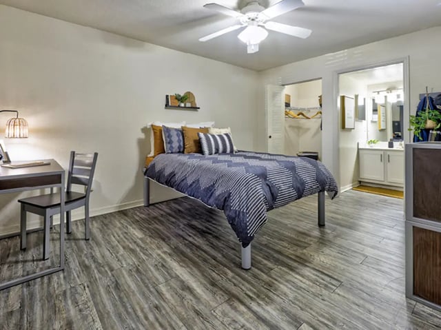 Bed desk chair and open closet bedroom at Mercury 3100 in Orlando Student Accommodation