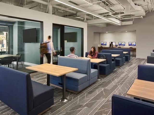 Blue booths tables and computers study area at North District in Riverside Student Accommodation