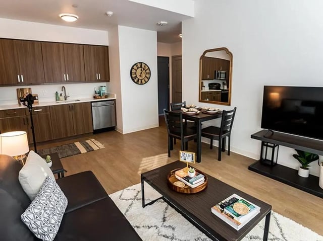 Sofa dining table TV kitchen living area at North District in Riverside Student Accommodation