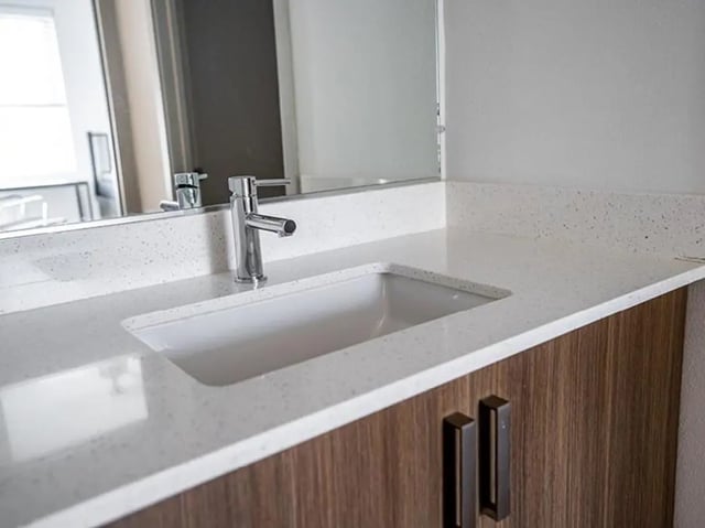 Sink faucet countertop cabinet with drawers bathroom at North District in Riverside Student Accommodation