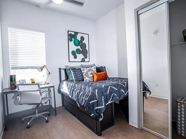 Bed desk chair and closet bedroom at North District in Riverside Student Accommodation