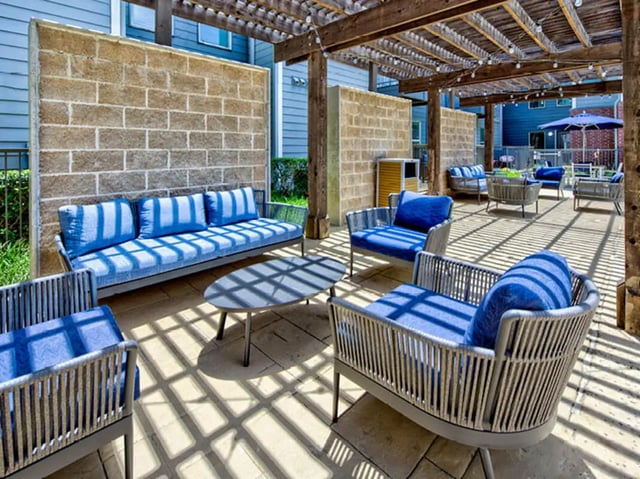 Outdoor seating with blue striped cushions patio area at The Arlie in Arlington Student Accommodation