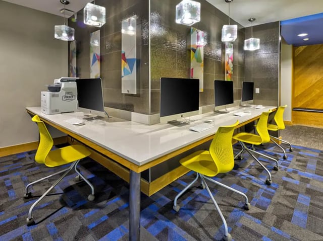 Computers printer and yellow chairs study area at The Arlie in Arlington Student Accommodation