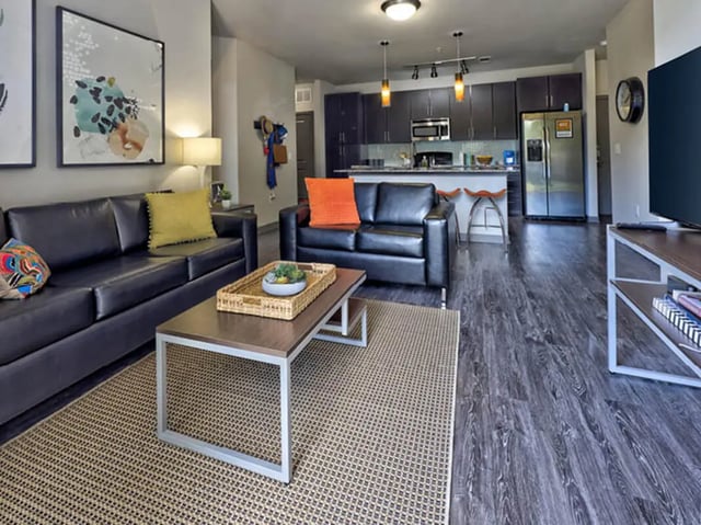 Sofas coffee table kitchen bar area Living Room at The Arlie in Arlington Student Accommodation