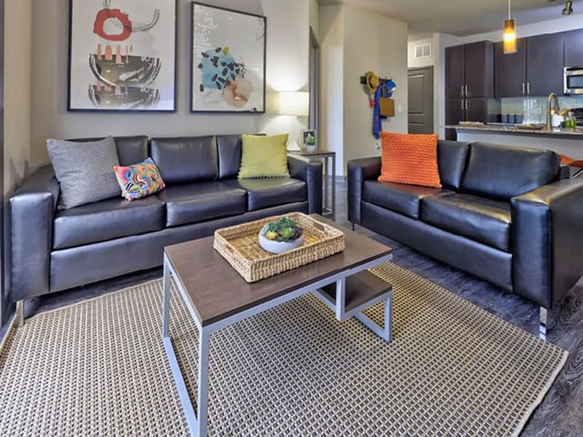 Leather sofas coffee table artwork living room at The Arlie in Arlington Student Accommodation