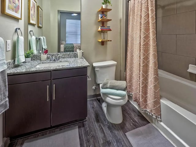 Sink toilet tub towels and shower curtain bathroom at The Arlie in Arlington Student Accommodation
