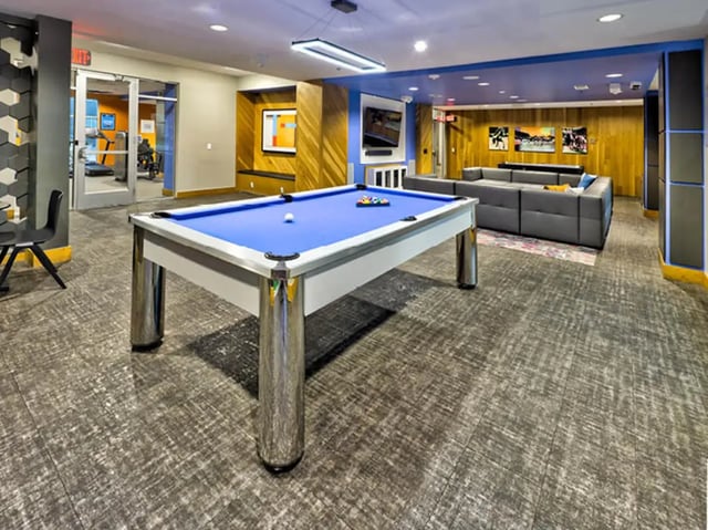 Billiard table lounge area with seating and gym. at The Arlie in Arlington Student Accommodation