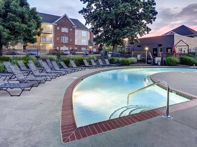 Lounge chairs by swimming pool exterior at Newtown Crossing in Lexington Student Accommodation
