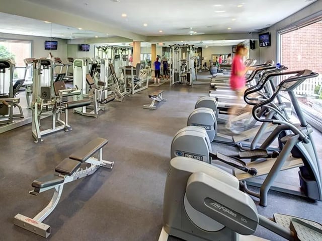 Weight machines treadmills benches exercise room at Newtown Crossing in Lexington Student Accommodation