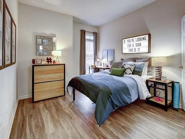 Bed desk dresser and decorative sign bedroom at Newtown Crossing in Lexington Student Accommodation