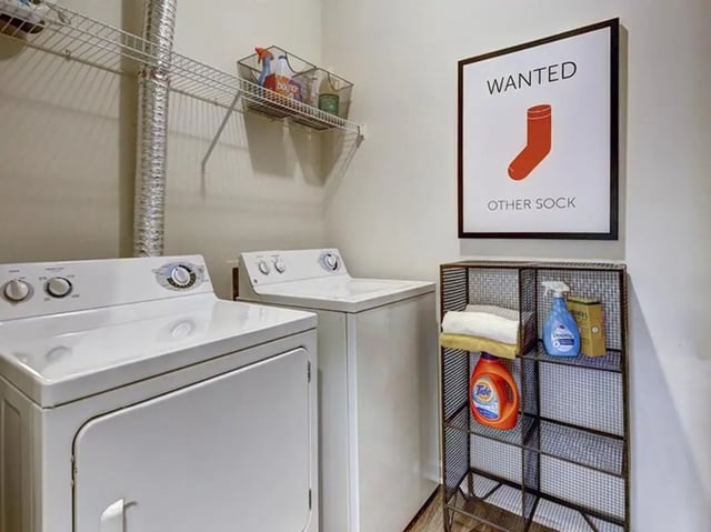 Laundry machines framed sock art shelving unit laundry room at Newtown Crossing in Lexington Student Accommodation